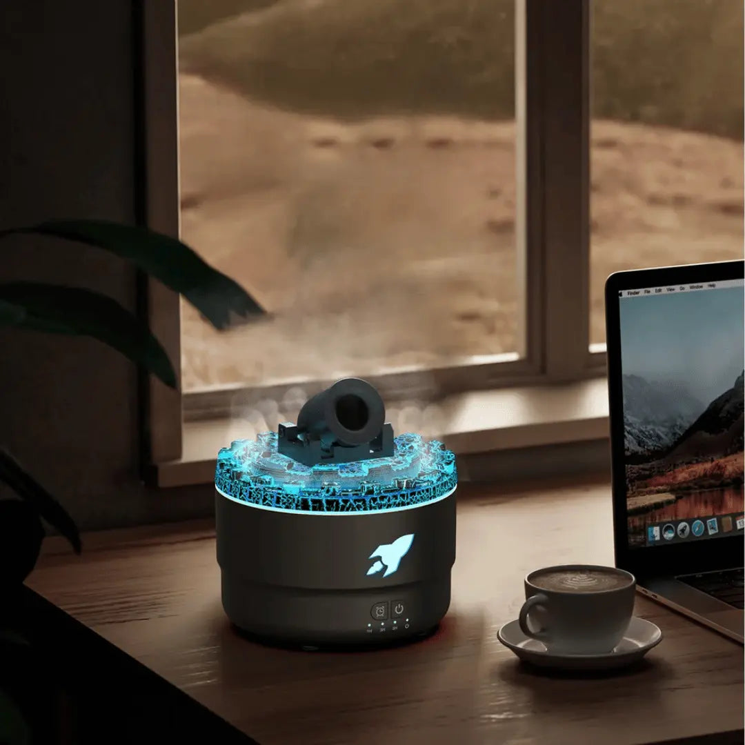 Glowing blue humidifier on a desk with a laptop and cup of coffee in the background.