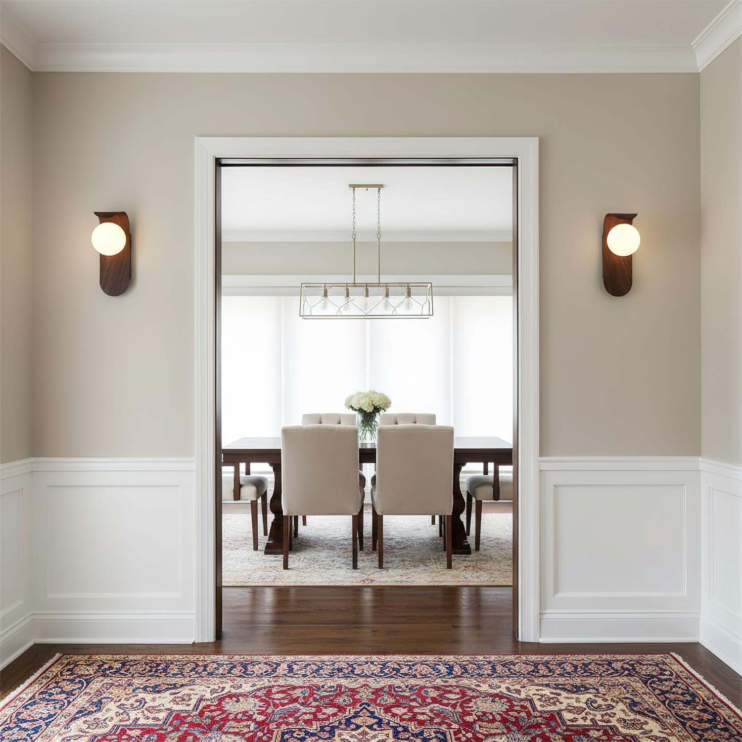 Dining room with a view from a hallway, featuring a table and chairs.