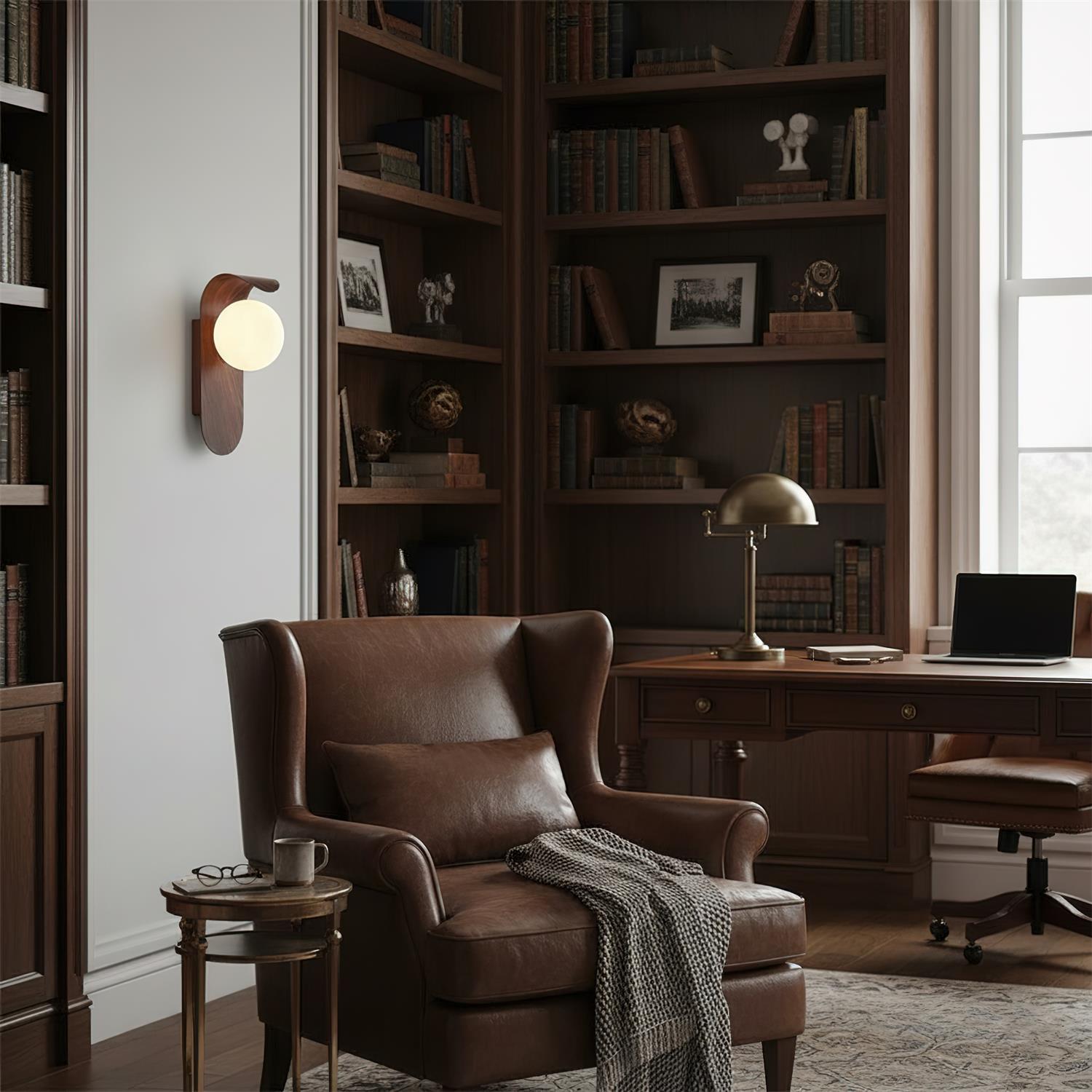 Cozy home office with leather armchair, bookshelves, and desk.