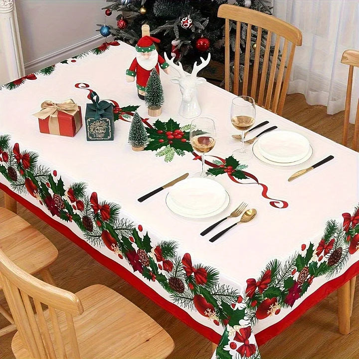 Dining table set for Christmas with a decorative tablecloth, plates, glasses, and cutlery.