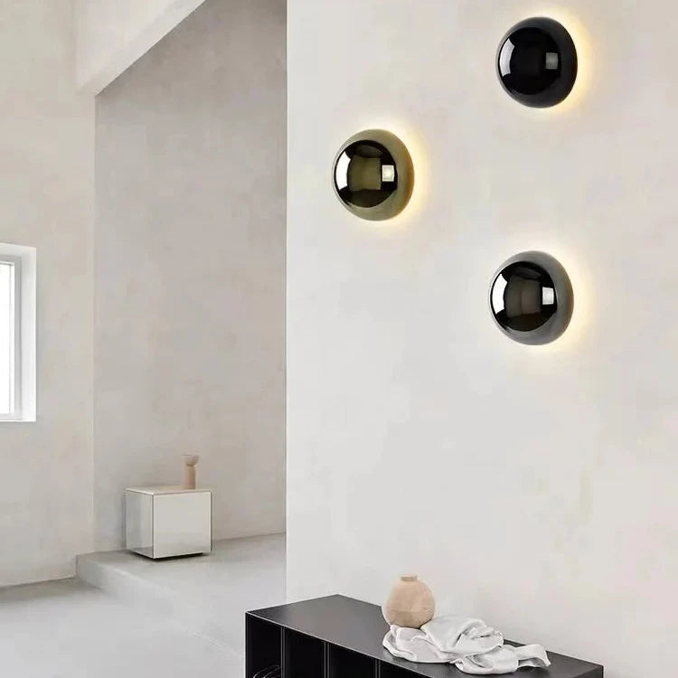Modern wall lights on a white wall with minimal decor.