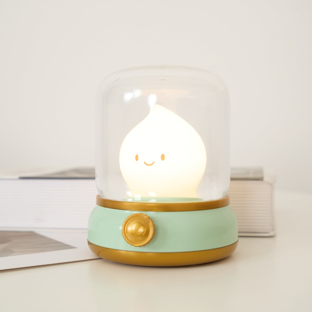 Cute lamp with a smiling face inside a glass dome on a light background