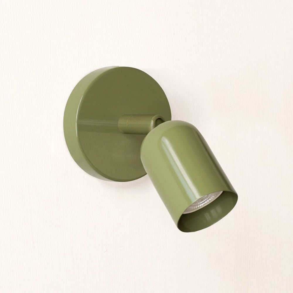 Green wall-mounted light fixture on a white background