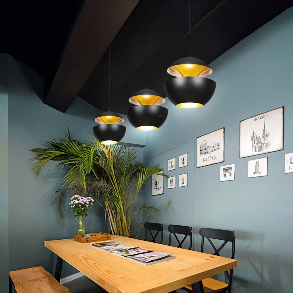 Modern dining room with pendant lights, wooden table, and decorative elements.