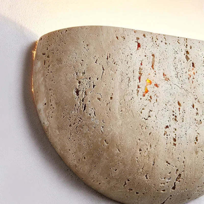 Textured stone wall sconce on a white background