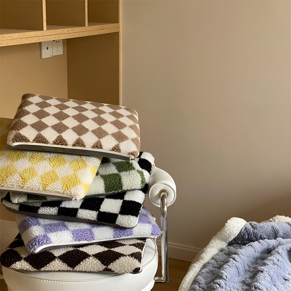 Stack of checkered towels on a chair against a beige wall