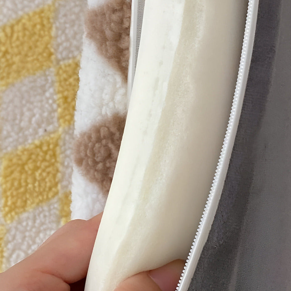 Close-up of a hand holding a white zipper against a textured fabric background