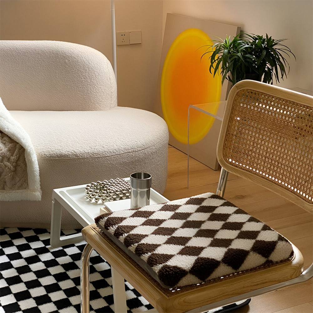 Modern living room with a white armchair, wicker chair, and coffee table.