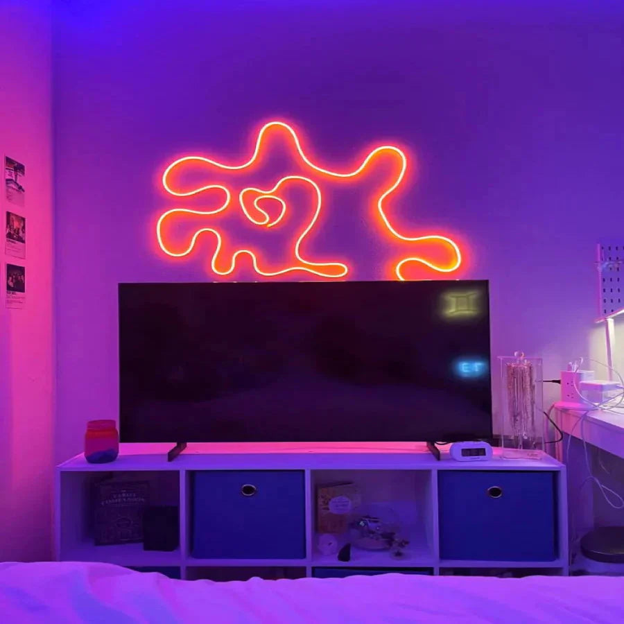 Neon sign shaped like a star with a heart in a room with purple lighting.