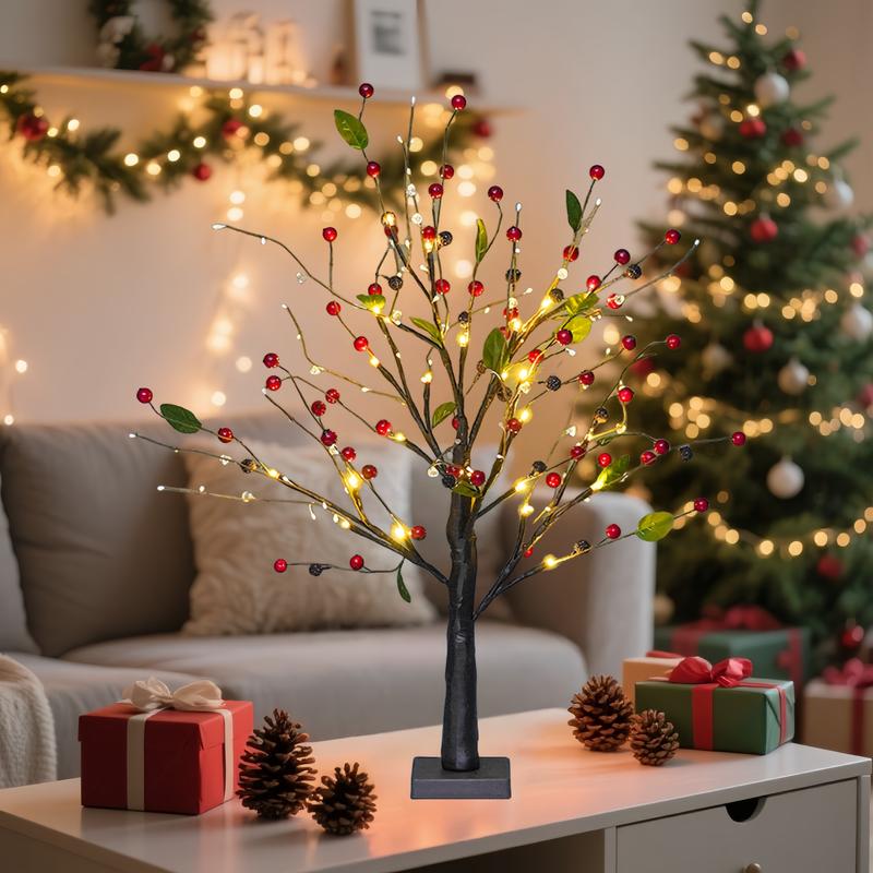 Decorative LED tree with lights on a table in a festive living room.