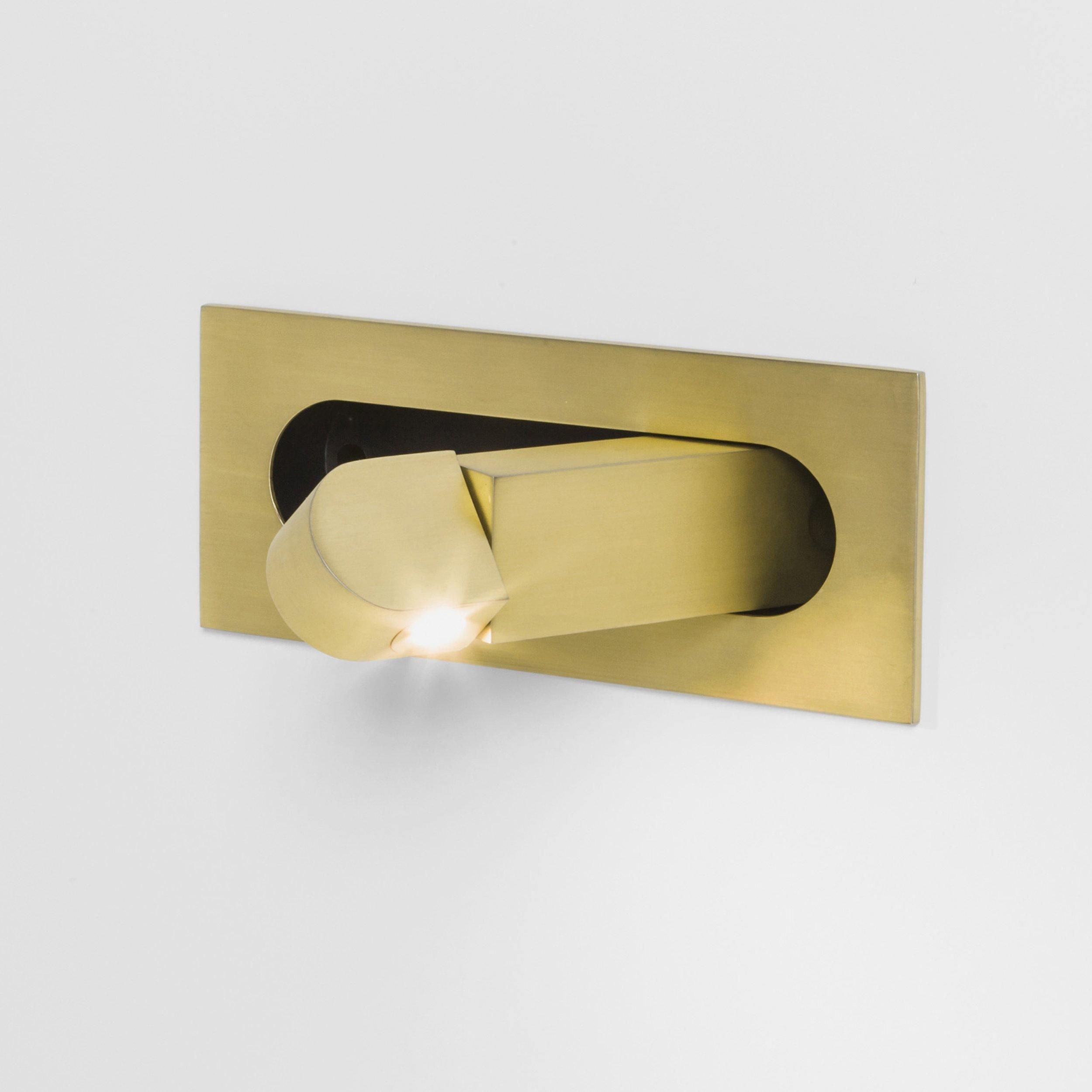 Gold wall-mounted fixture on a white background