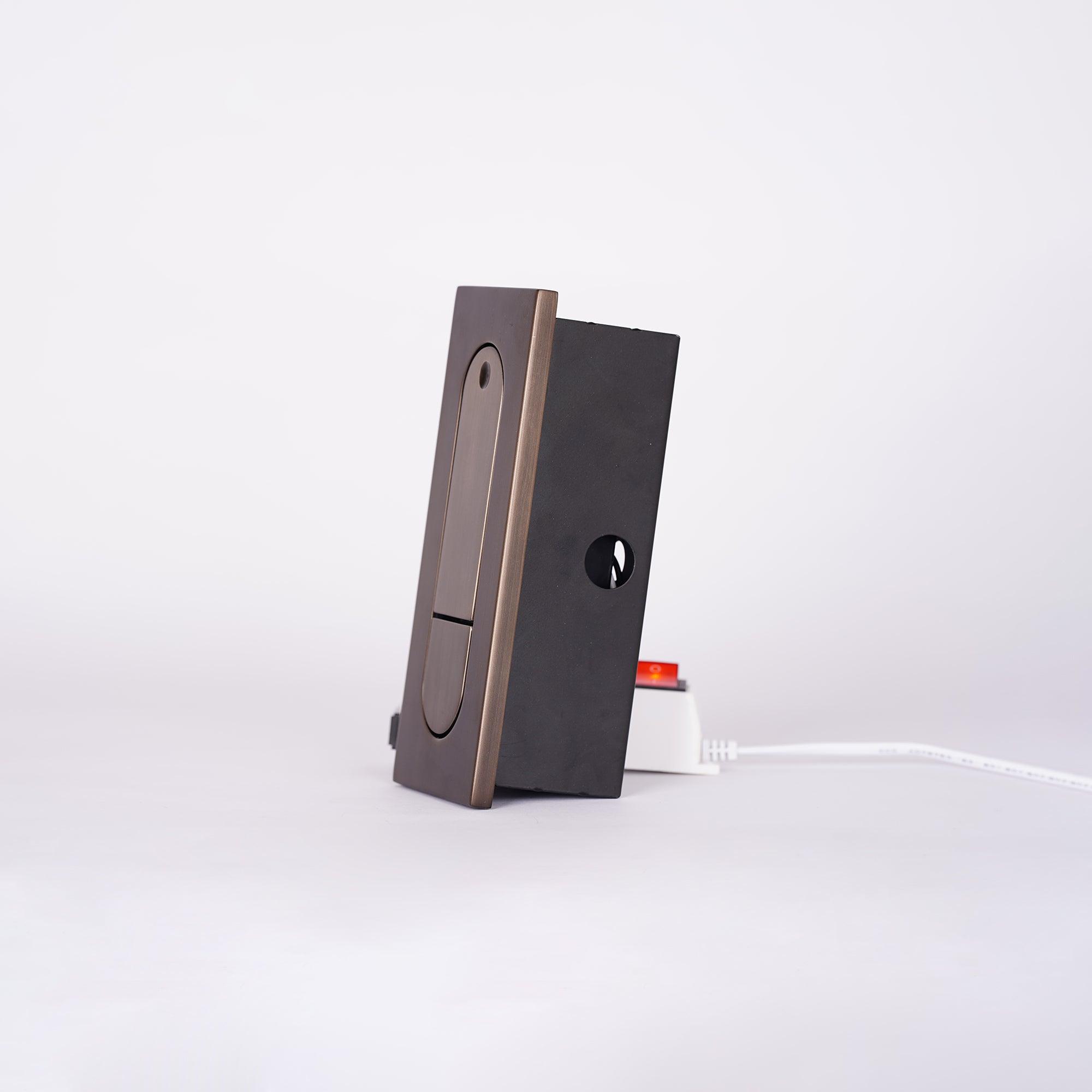 Black electronic device with a white cable on a light gray background