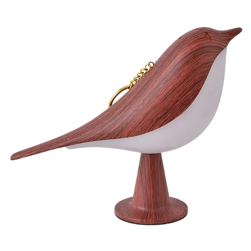 Wooden bird-shaped object with a white body and gold chain on a white background