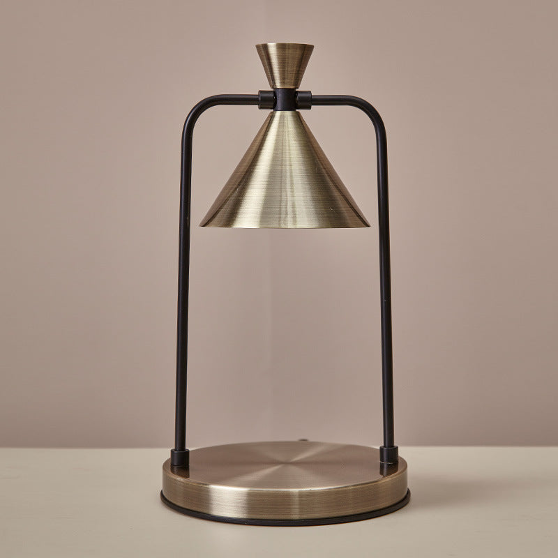 Table lamp with brass shade and base on a beige background
