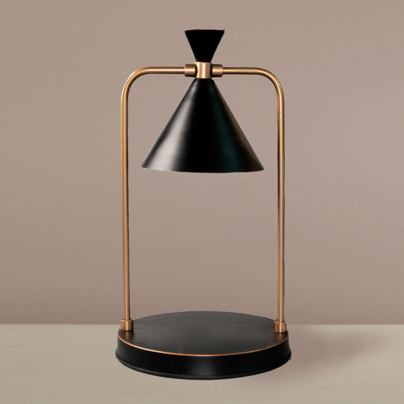 Modern table lamp with black and gold design on a beige background