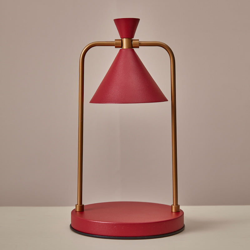 Red and gold table lamp on a beige background