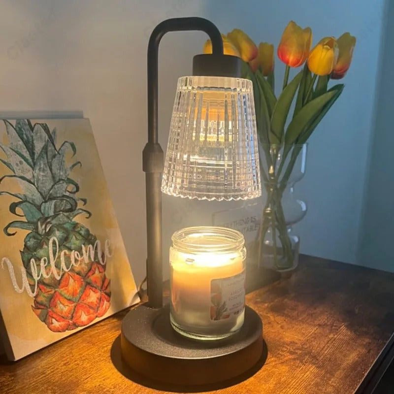 Lantern with candle on a table next to a 'Welcome' sign and vase of tulips