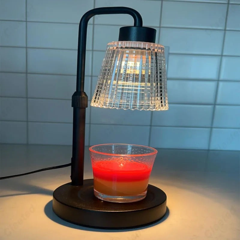 Lamp with a glass container holding a red candle on a tiled wall background