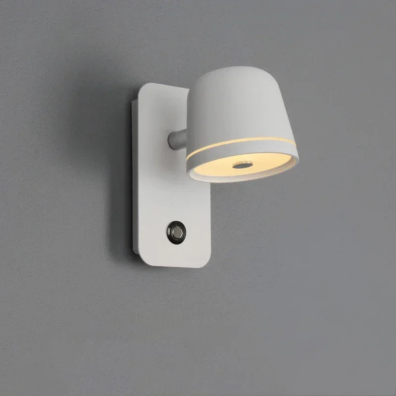 Wall-mounted light fixture with gray shade and white base on a gray background