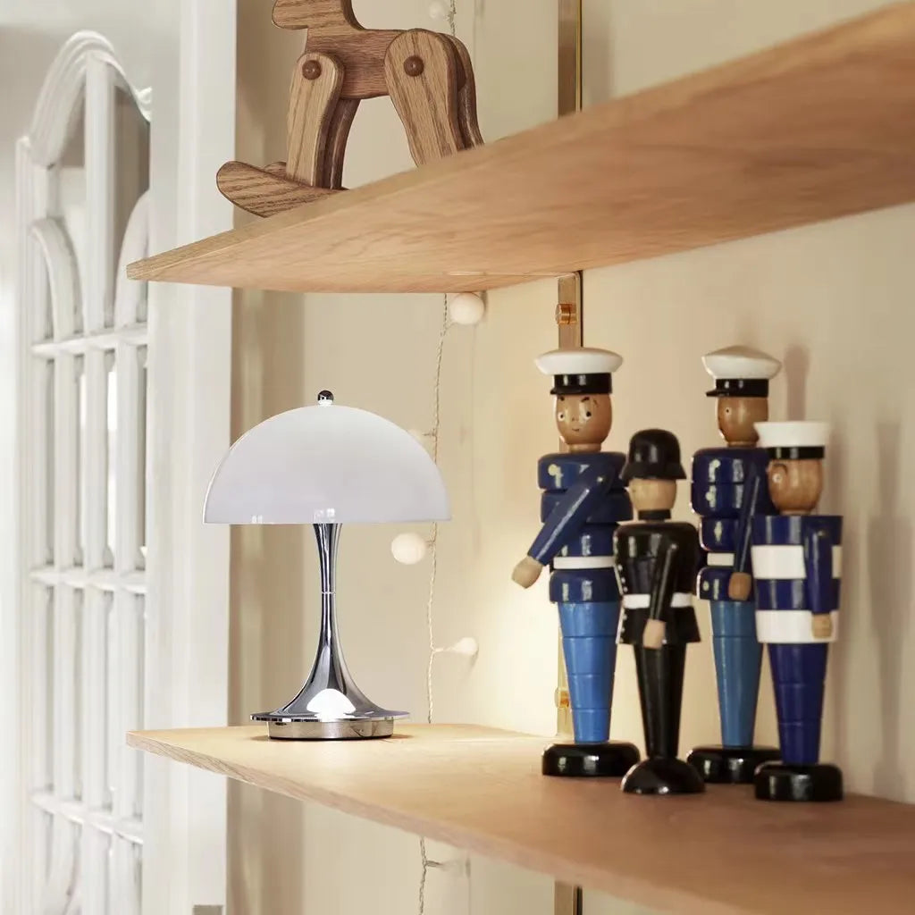 Table lamp and decorative nutcrackers on a wooden shelf