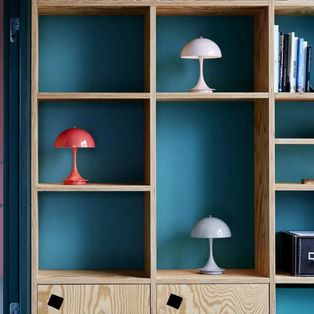 Wooden shelves with decorative lamps against a teal wall