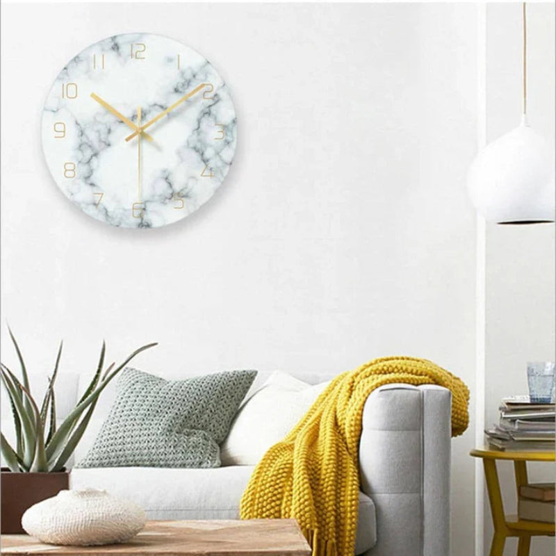 Marble-patterned wall clock on a white wall above a sofa with a yellow blanket.