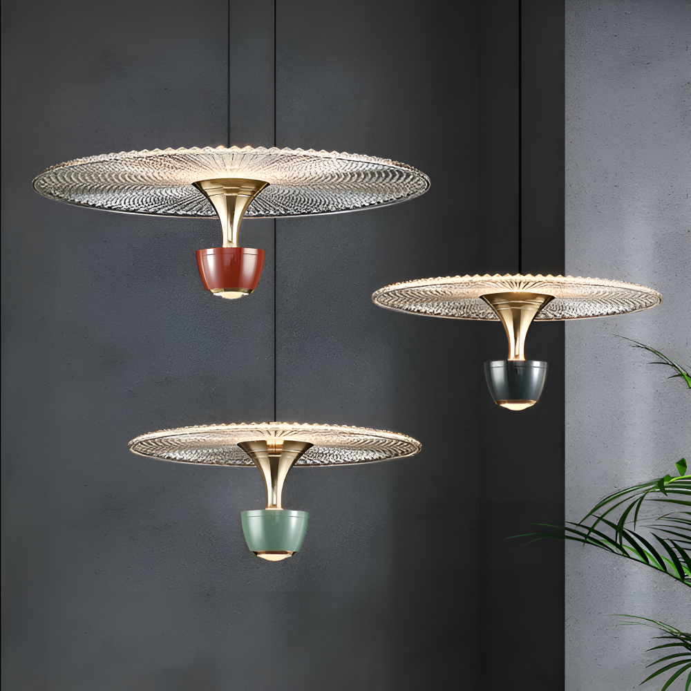 Three decorative ceiling lights with gold bases and colorful ceramic parts against a dark wall.