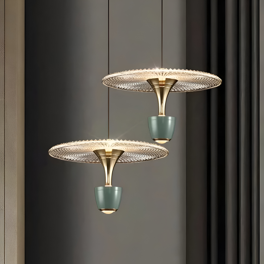 Two modern pendant lights with gold and teal design on a dark background
