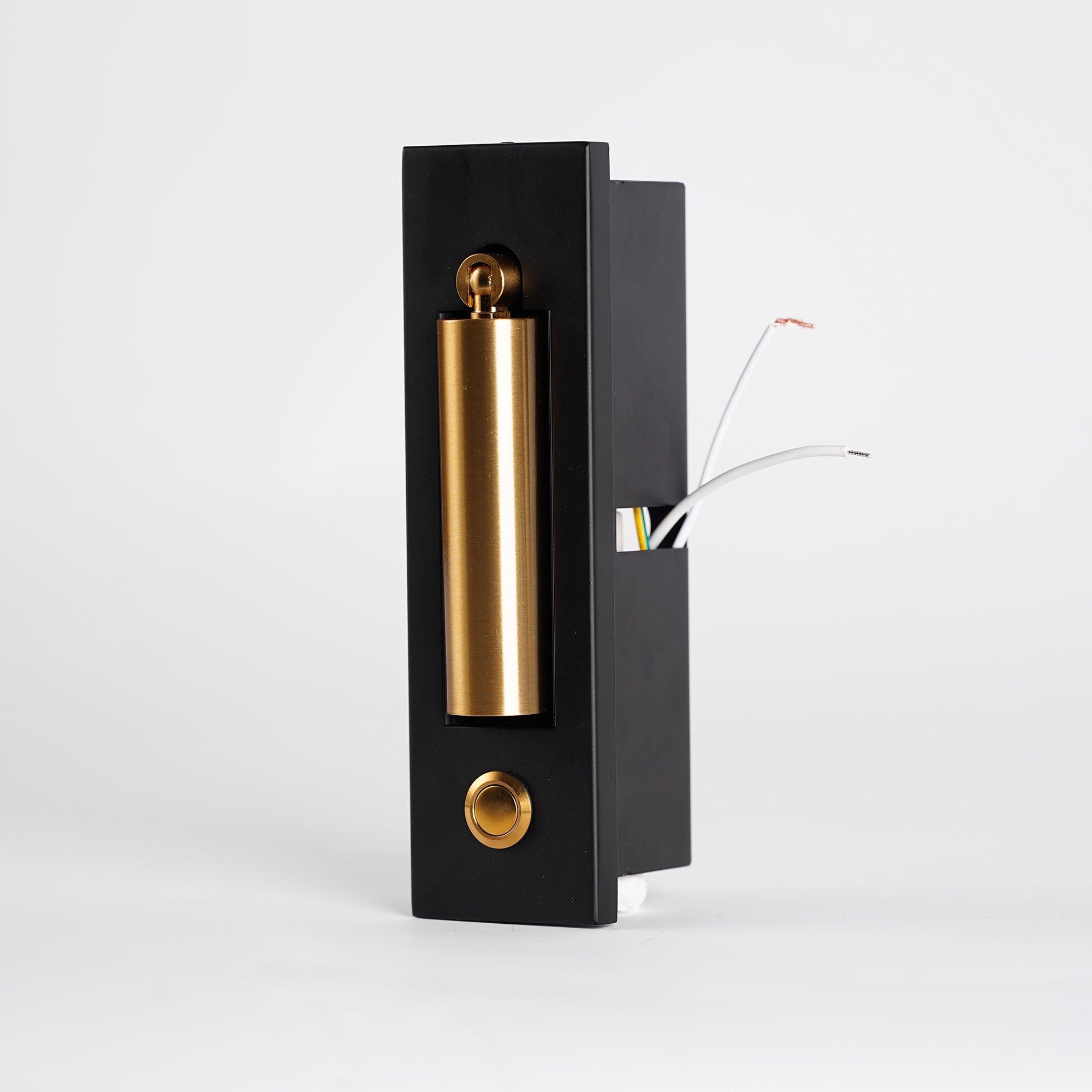 Decorative wall sconce with black and gold finish on a white background