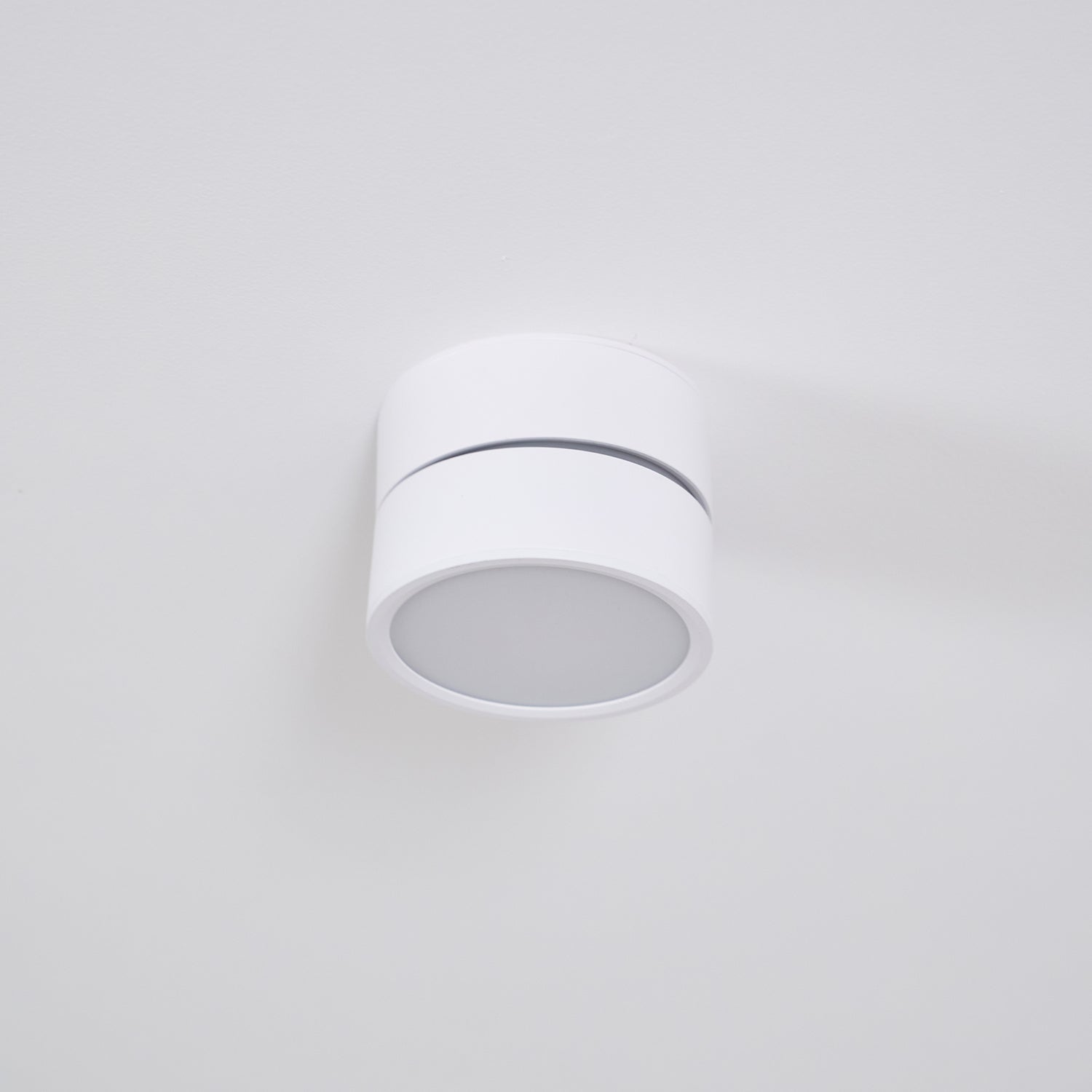 White ceiling light fixture on a light gray background