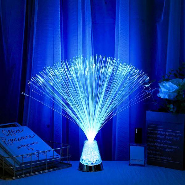 Fiber optic light emitting a blue glow against a dark curtain background