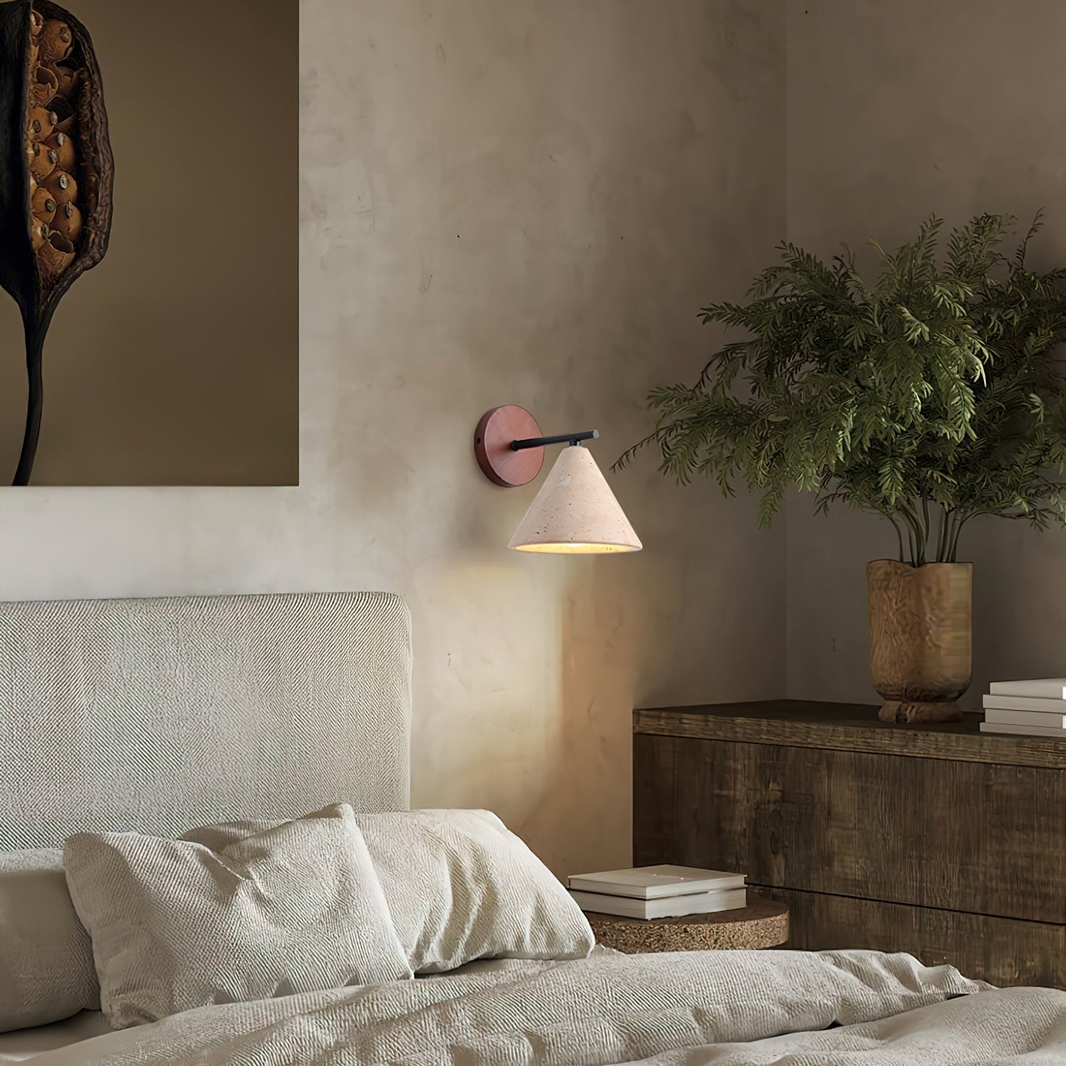 Modern bedroom with a bed, wall lamp, and plant
