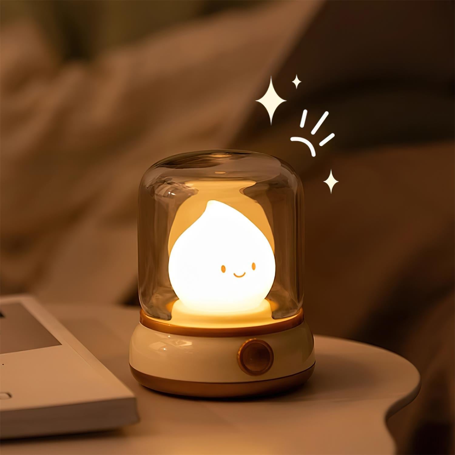 Cute lamp with a smiling face inside a glass dome on a blurred background