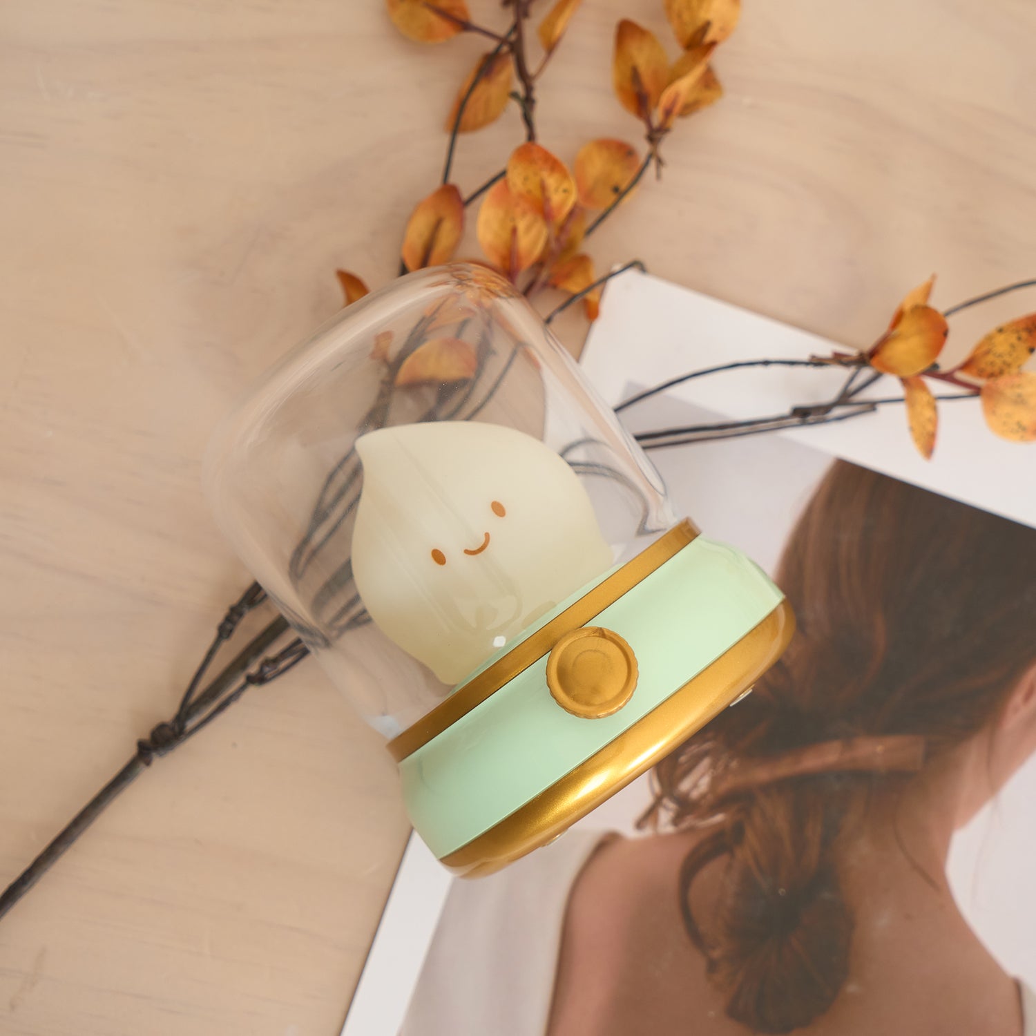 Small lamp with a cat design on a surface with a blurred background