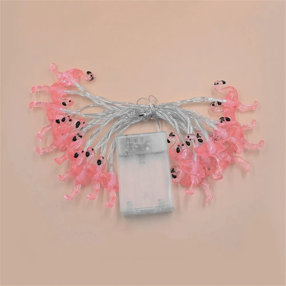String lights shaped like flamingos on a beige background