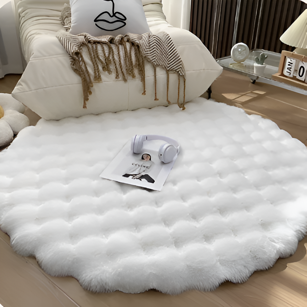 White fluffy rug on a wooden floor with a pillow and headphones on top