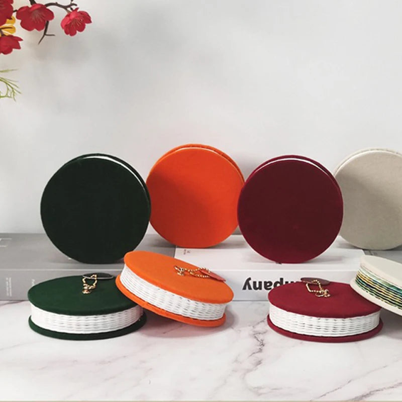 Set of round, multicolored containers with visible brand name on a white surface.