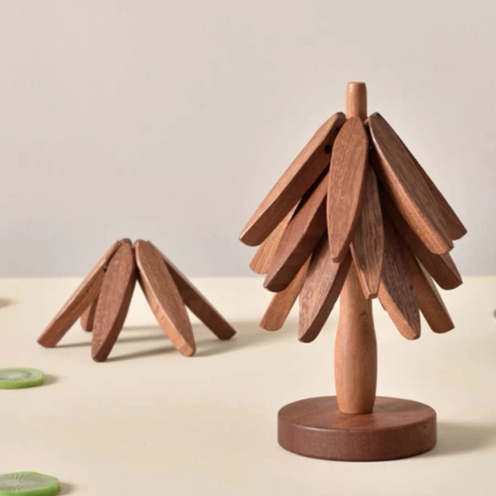 Wooden decorative items resembling trees on a neutral background