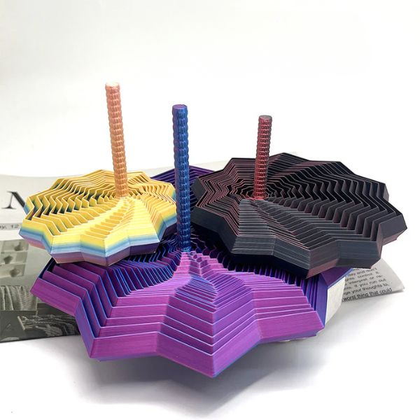 Colorful 3D paper models stacked on a white surface