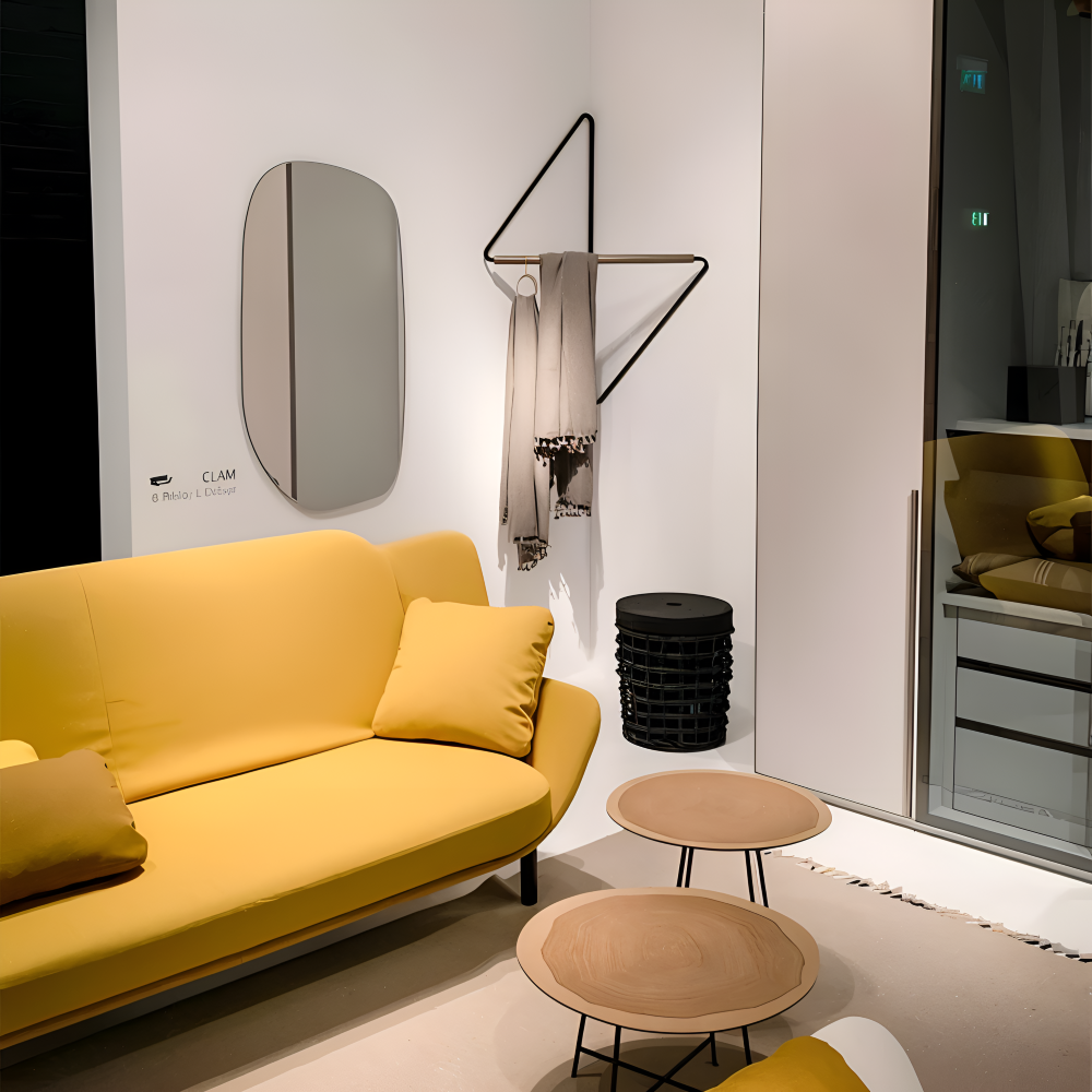 Modern living room with a yellow sofa, small tables, and decorative items.