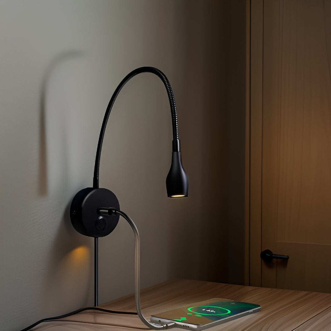 Modern wall-mounted lamp with flexible arm on a wooden surface in a dimly lit room.
