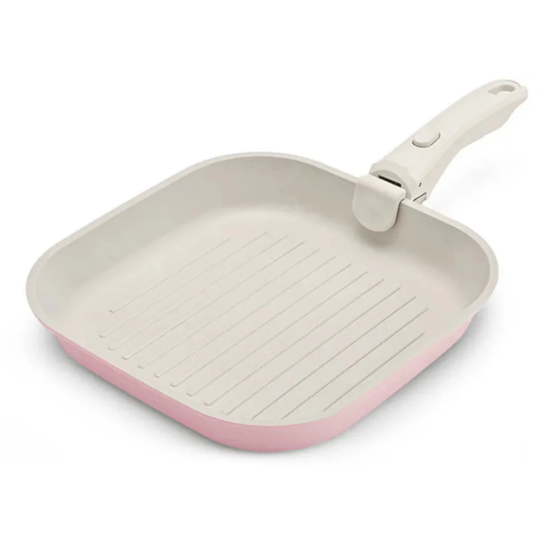 Square ceramic cookware with pink exterior and beige interior on a white background
