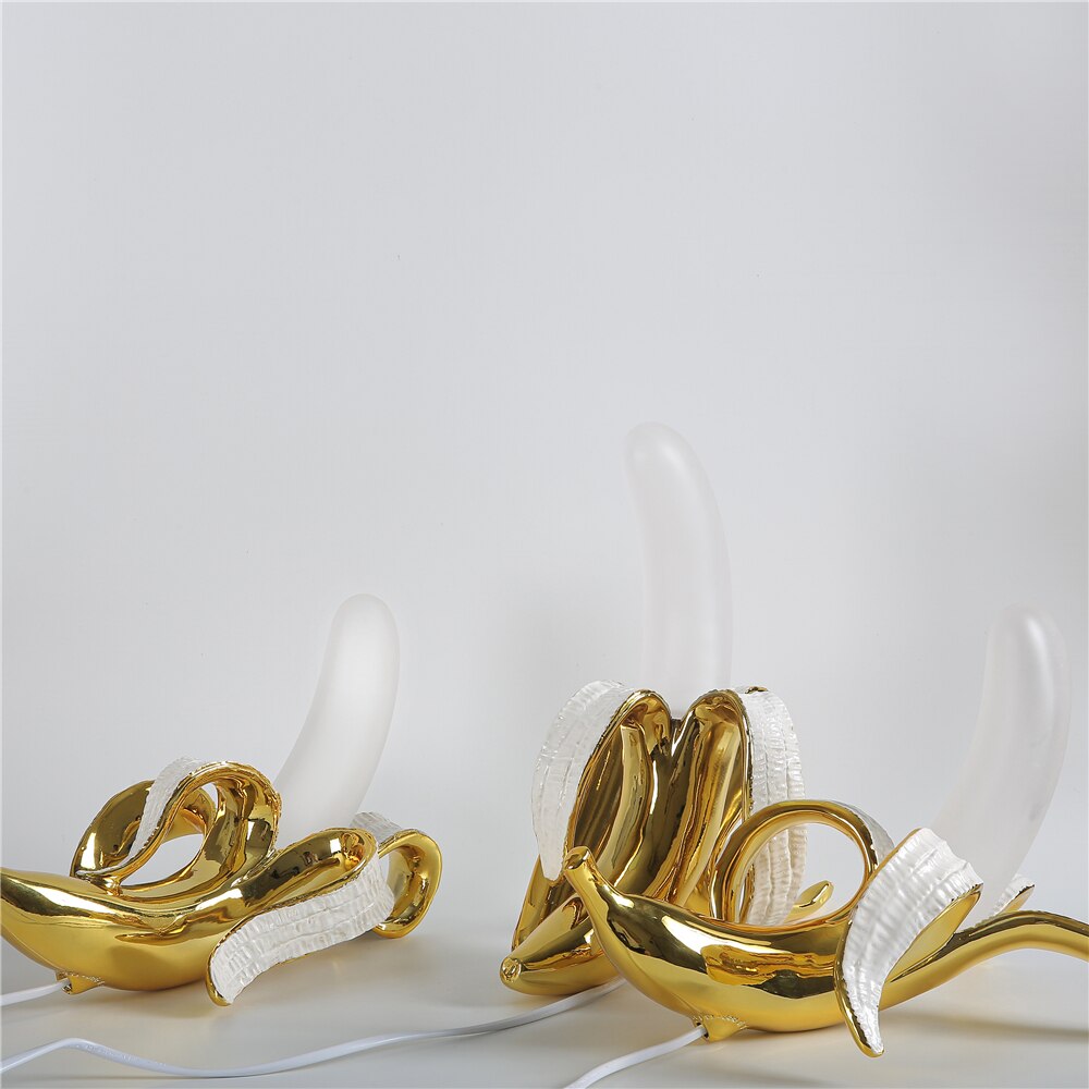 Gold and white decorative items on a light gray background