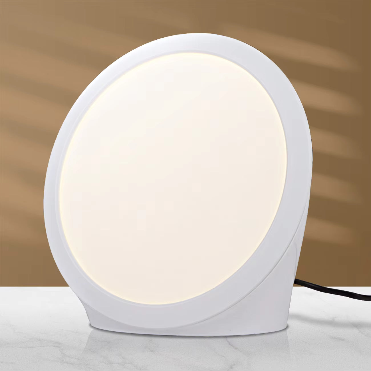 Round table lamp with a white base and circular shade on a marble surface.