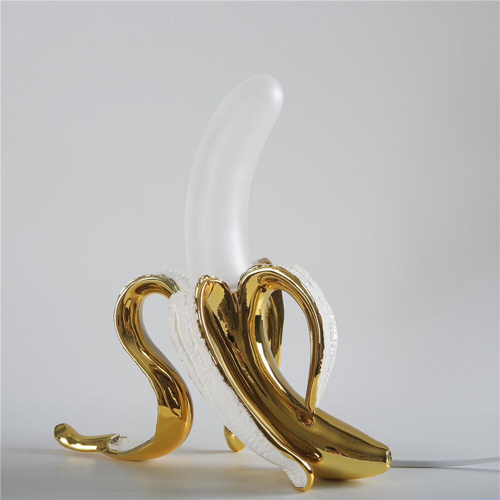 Gold and white decorative item resembling a swan on a light gray background