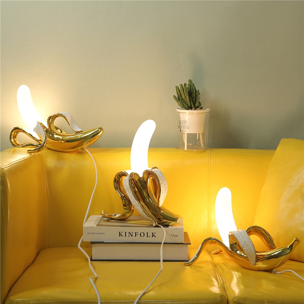 Decorative lamps with white shades on a yellow couch