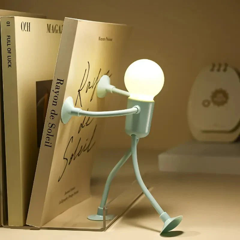 Light bulb-shaped character reading a book with a warm glow