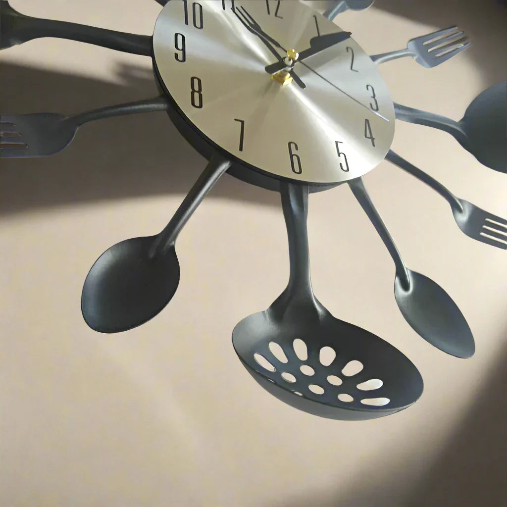 Wall clock with spoon, fork, and ladle design on a beige background