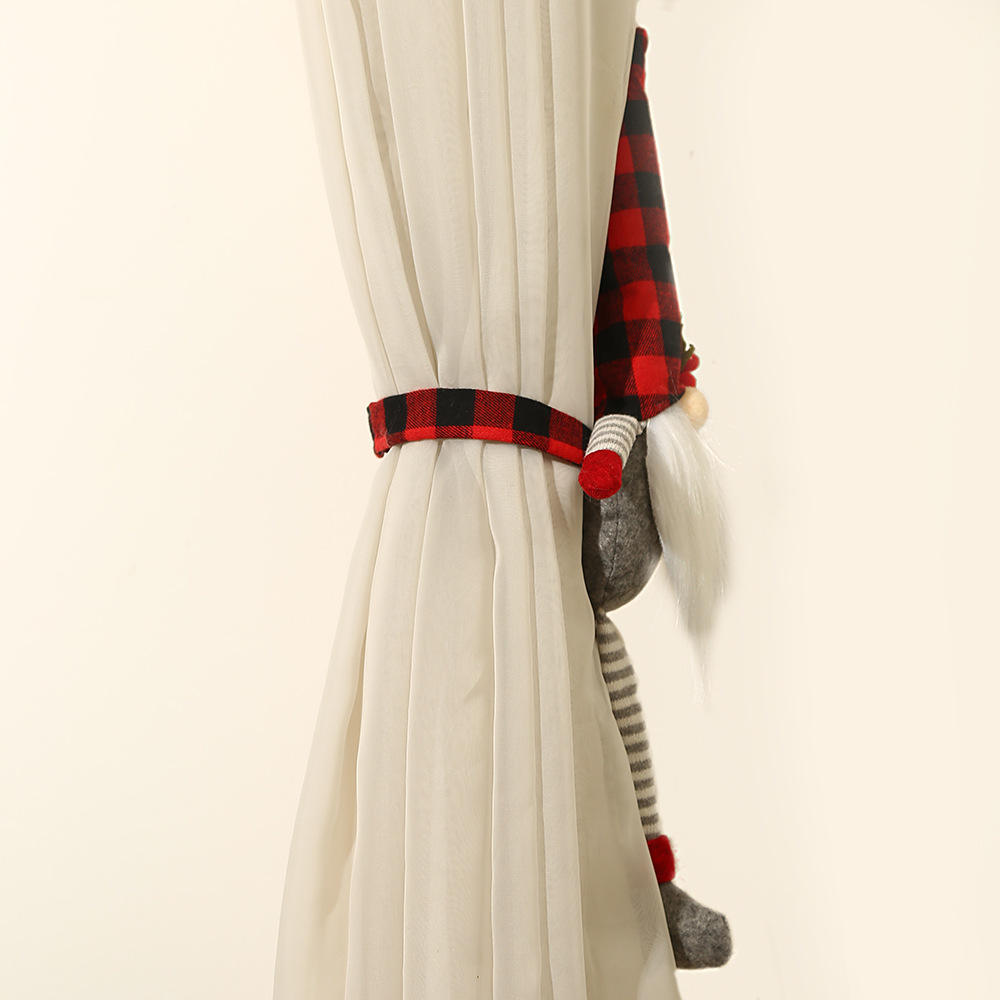 Curtain tieback with gnome design and plaid ribbon on a white curtain