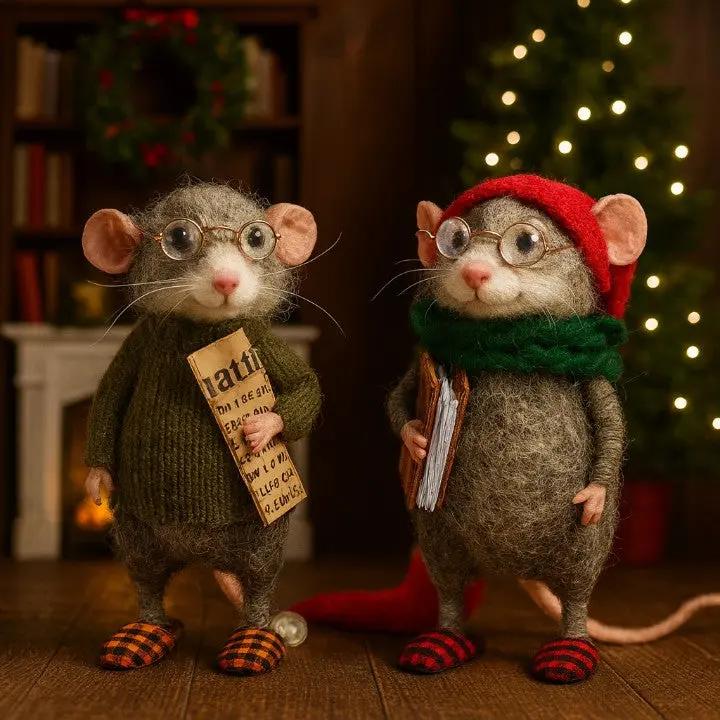Two toy mice in festive attire with a Christmas tree and books in the background